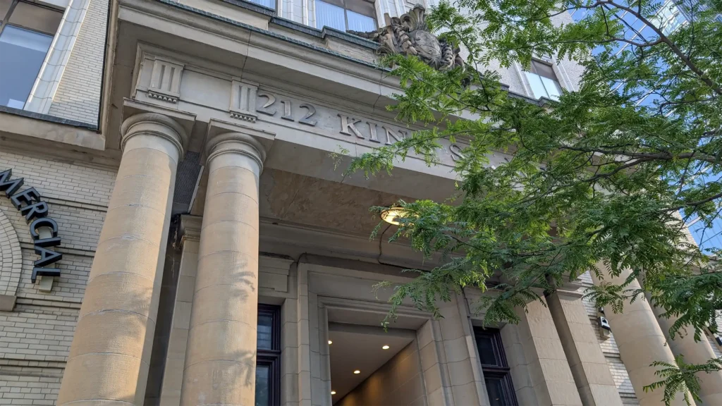 Front of Elkove Insurance Advisors' building at 212 King Street West, featuring grand columns.