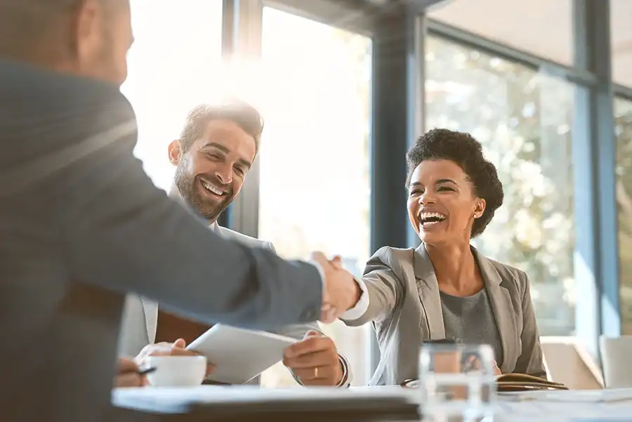 Business professionals shaking hands, symbolizing M&A deal protection.