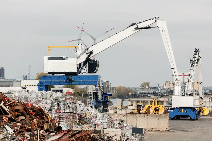 Heavy machinery in recycling yard, symbolizing industry-specific insurance.