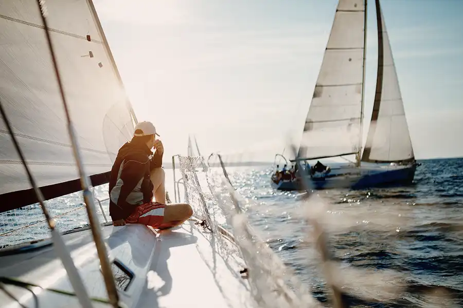 Person on sailboat, symbolizing watercraft and valuable collectibles insurance.